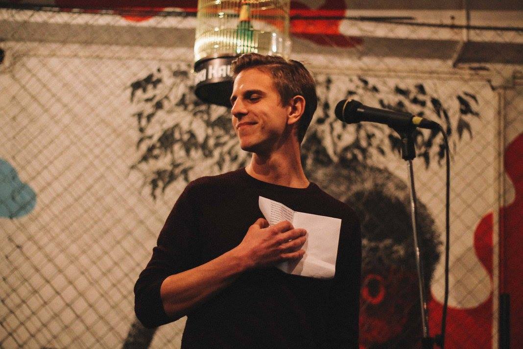 Ivor holding a notebook beside a microphone